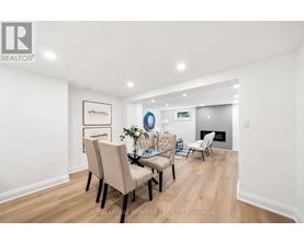 A dining room with a table set for four.