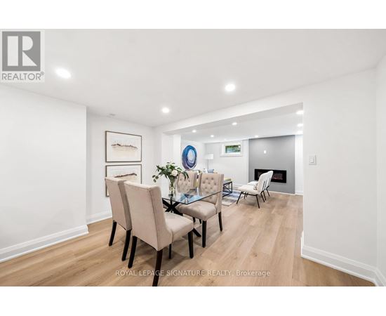 A dining room with a table set for four.