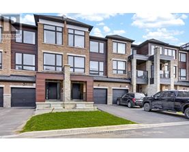 A modern apartment building with cars parked in front.