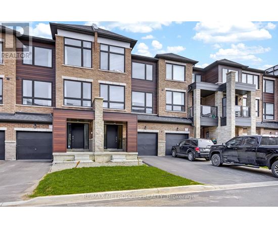 A modern apartment building with cars parked in front.