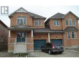 A two-story house with a car parked in front.