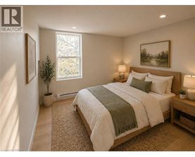 A bedroom with a large bed and a window.