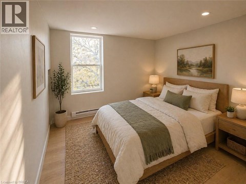 A bedroom with a large bed and a window.