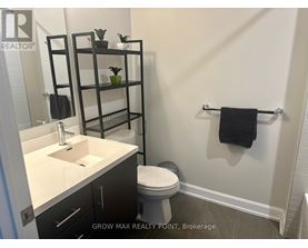 A bathroom with a sink, toilet, and shelves with plants.