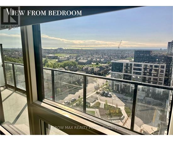 A view from a bedroom window looking out at a cityscape.
