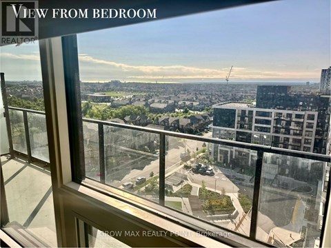 A view from a bedroom window looking out at a cityscape.