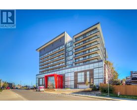 A modern building with a glass facade and a red entrance.