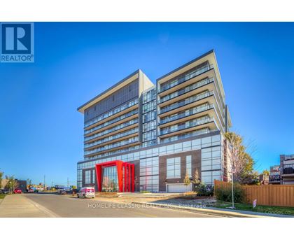 A modern building with a glass facade and a red entrance.