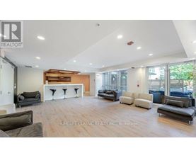 A spacious living room with a variety of seating options and a fireplace.