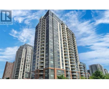 A tall residential building with a clear blue sky in the background.