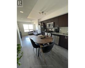 A modern kitchen and dining area with a wooden table and chairs.