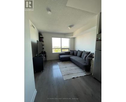 A living room with a grey couch and a television.