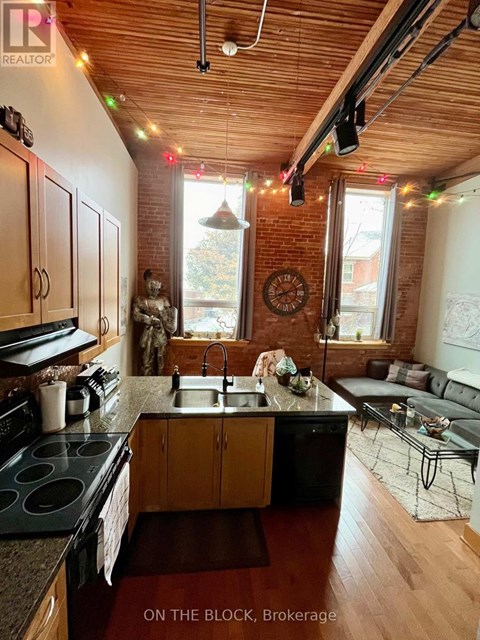 A kitchen with wooden cabinets and a black stove top oven.