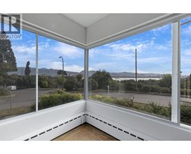 A sunny day with a view of the street and mountains from a window.