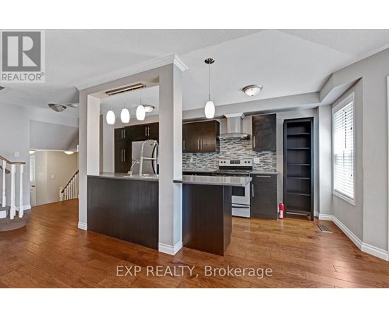 A kitchen with a bar area and a refrigerator.