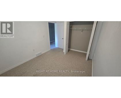 A bedroom with a closet and a doorway leading to another room.