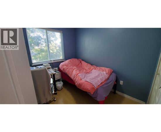 A bedroom with a bed and a desk.
