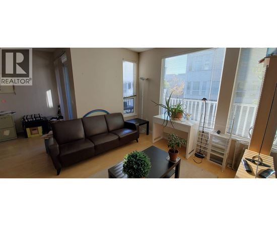 A living room with a brown couch and a sign that says REALTOR.