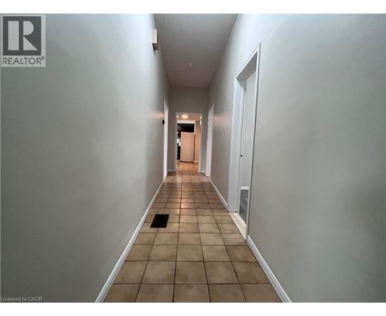 A long hallway with a door at the end.