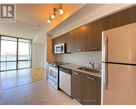A kitchen with a refrigerator, stove, and microwave.