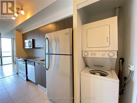 A white refrigerator and oven in a kitchen.