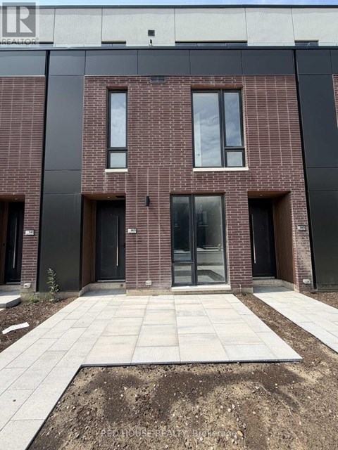 A building with a brick facade and a large glass door in the center.