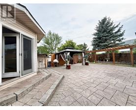 A backyard with a patio and a gazebo.