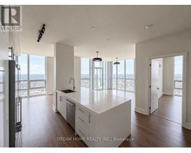 A modern kitchen with a large island and a view of the beach.