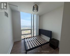 A bedroom with a large bed and a view of the city.