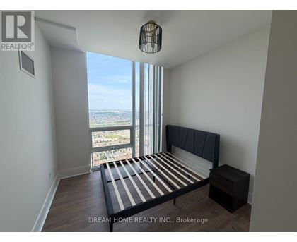 A bedroom with a large bed and a view of the city.