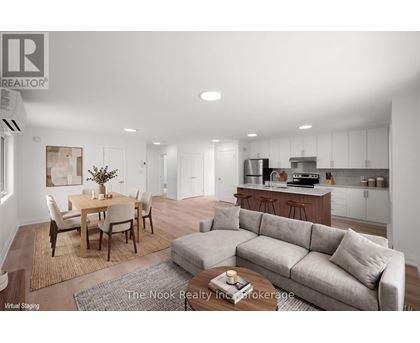 A modern living room with a dining table and a grey sofa.