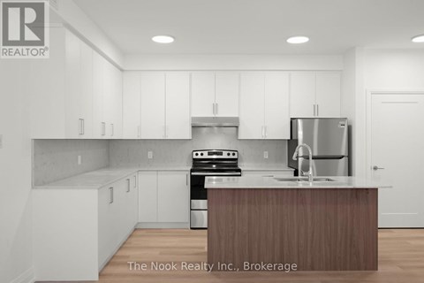 A modern kitchen with white cabinets and a wooden island.