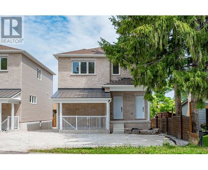 A house with a brown roof and a white fence.