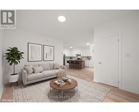 A living room with a couch, coffee table, and a plant.
