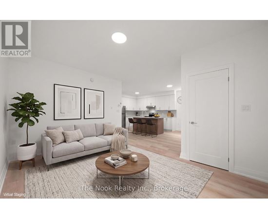A living room with a couch, coffee table, and a plant.
