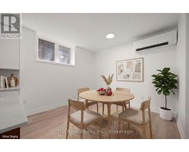 A dining room with a table and chairs.