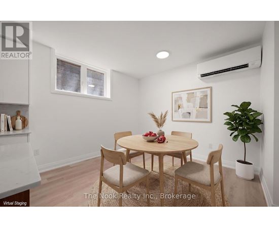 A dining room with a table and chairs.