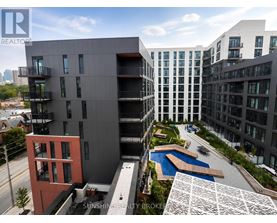 A modern building with a pool in the courtyard.