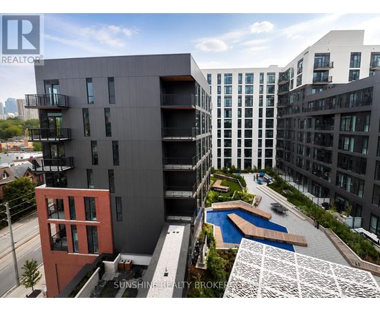 A modern building with a pool in the courtyard.