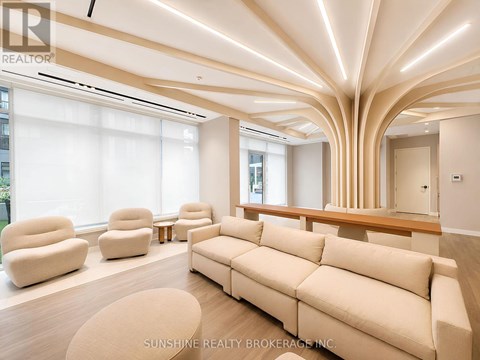 A living room with a large couch and a long table.