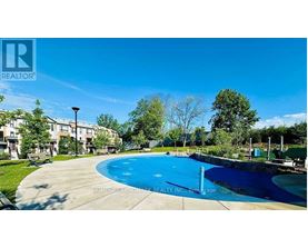 A swimming pool in a residential area with a clear blue sky.