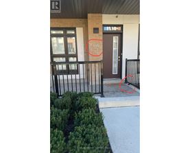 A black metal railing is in front of a building.