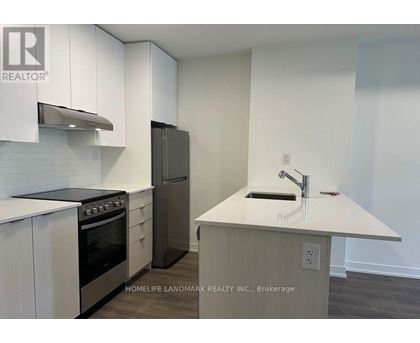 A kitchen with white cabinets and a stainless steel oven.