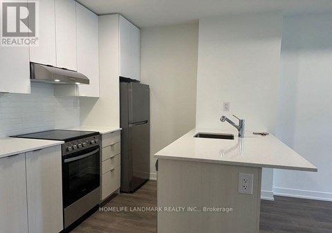 A kitchen with white cabinets and a stainless steel oven.