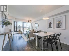 A dining room with a white table and chairs.
