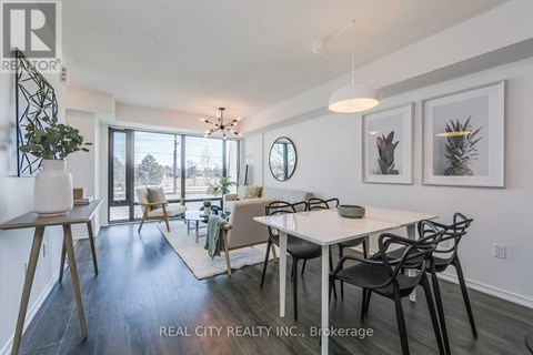 A dining room with a white table and chairs.