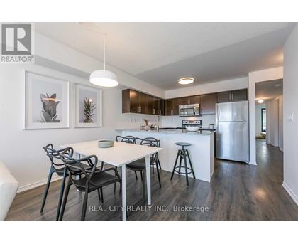 A modern kitchen with a dining table and chairs.