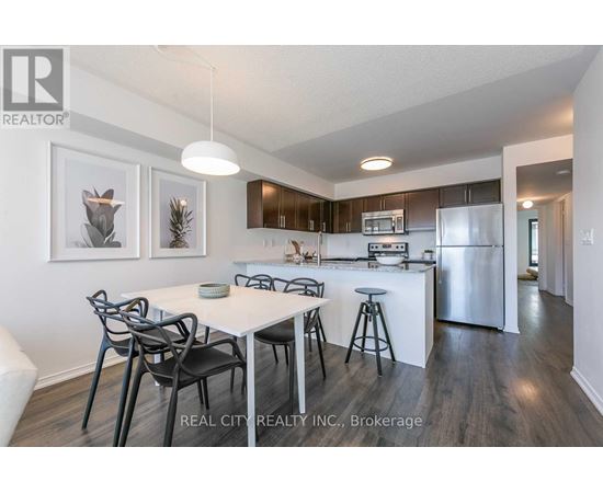 A modern kitchen with a dining table and chairs.