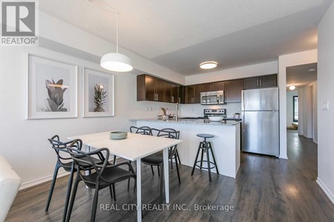 A modern kitchen with a dining table and chairs.