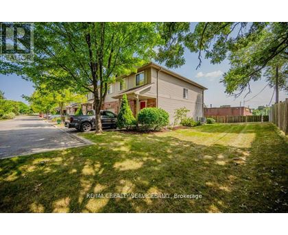 A residential area with a house, trees, and a parked car.